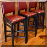 F06. Set of 3 red leatherette barstools.